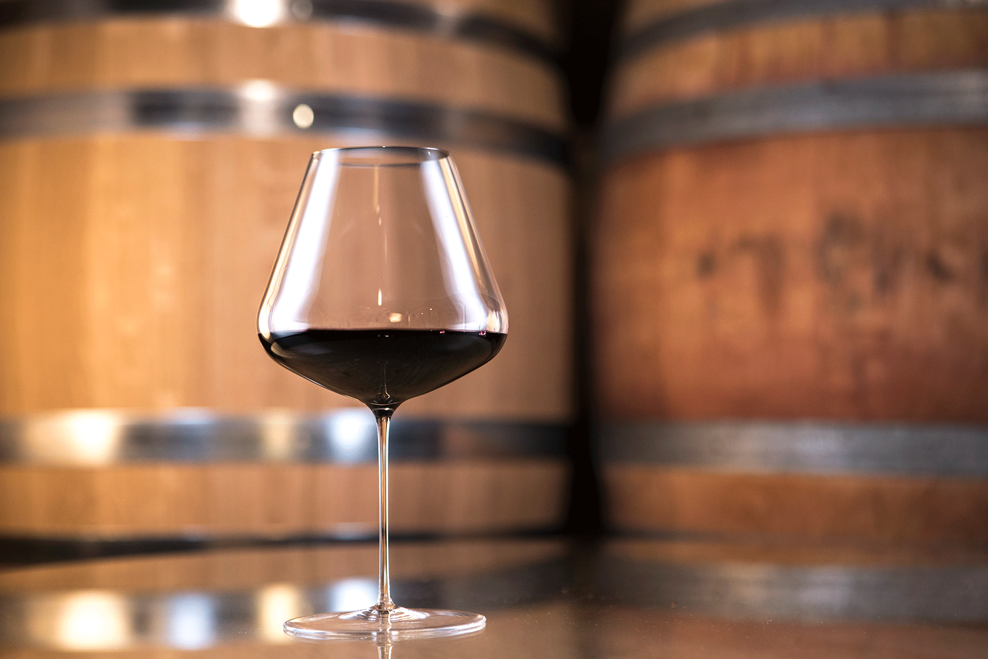 red wine glass on barrel